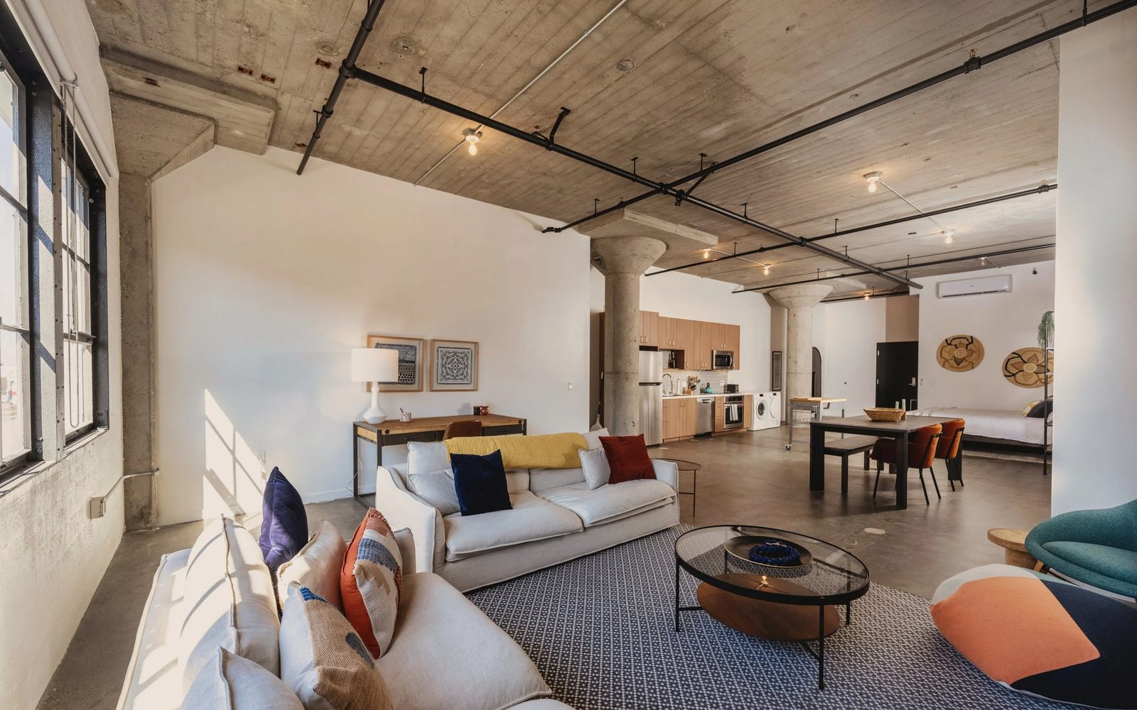 A work/live loft interior at The Storehouse Lofts in Alameda, with exposed concrete columns and ceilings