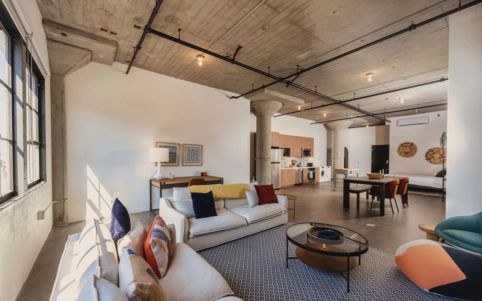 A work/live loft interior at The Storehouse Lofts in Alameda, with exposed concrete columns and ceilings